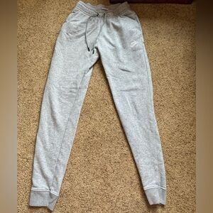 Gray Nike sweatpants. Tie waist. Cuffed ankles.